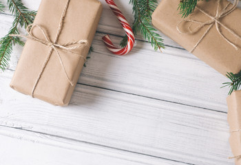 Christmas gift box at white wooden table. with space for inscriptions