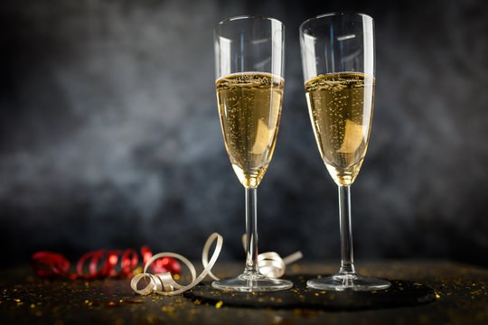 Two champagne glasses in golden glitter
