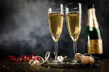 Two champagne glasses in golden glitter