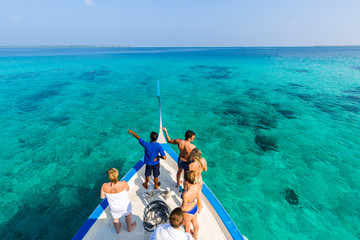 People on a boat on tropical sea background. Adventure journey on sea - No recognizable faces