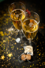 Two champagne glasses in golden glitter