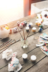 Paint brushes and scattered paints