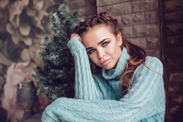 Portrait of a beautiful woman near a Christmas tree. New Year.