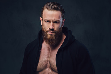 Bodybuilder in a black jacket with a hood.