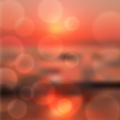 Blurred sea sunset background with light on lens