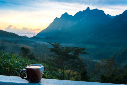  coffee cup over blurred image of dao mountain view,Chiang Mai,Thailand.