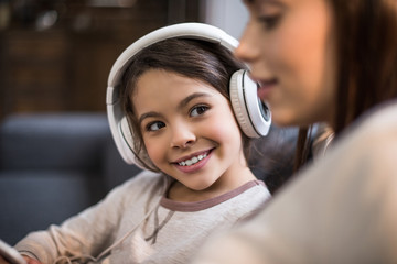 smiling daughter in headphones