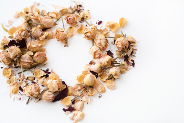 Heart symbol made of flovers and leaves on white background with place for signature