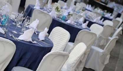 elegant table set with white chiars in the restaurant