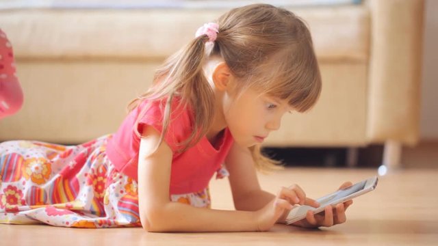Little girl watching photos in smartphone