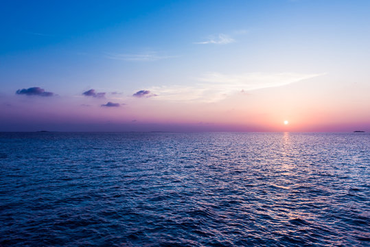 The sun sets over the horizon. Sunset over the Indian Ocean. Maldives.