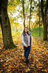 Brunette girl on majestic autumn fall forest.