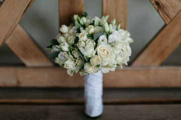 small wedding bouquet  on wooden chair