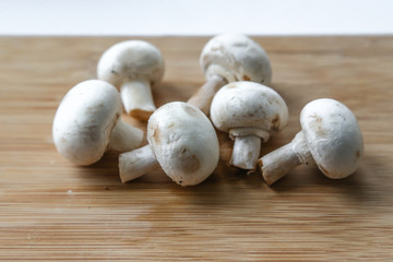 Fresh mushrooms-champignons on a wooden table