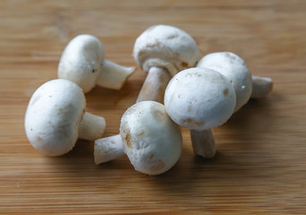 Fresh mushrooms-champignons on a wooden table