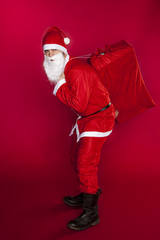 Fototapeta na wymiar Santa Claus is carrying a great bag of gifts