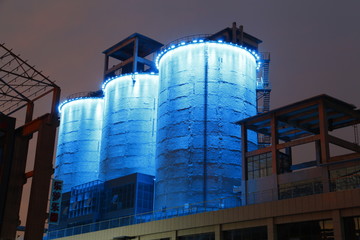 Cement silo and production building at night