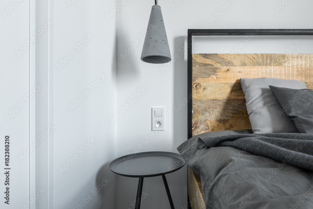 Wall mural concrete lamp over industrial bed