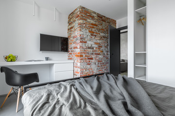 Bedroom with brick wall