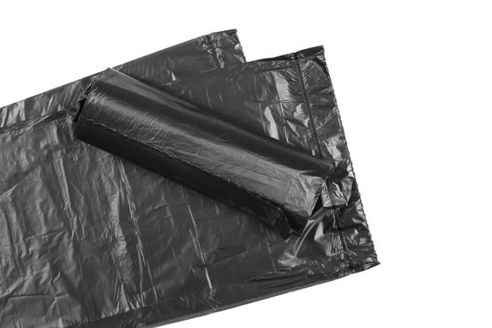 Black roll of plastic garbage bag isolated on white background, top view