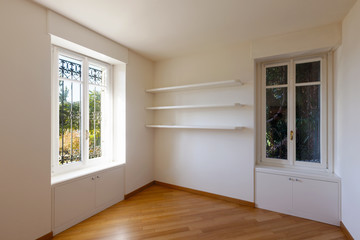 Empty white room with window