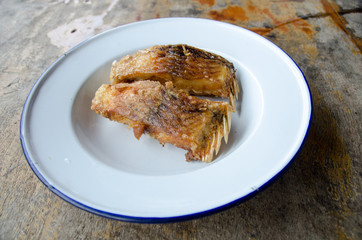 Delicious Asian fish fry served on a wooden table.