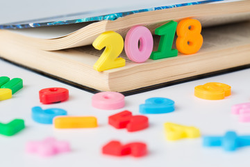 Naklejka premium 2018 inscription of colored figures in the book