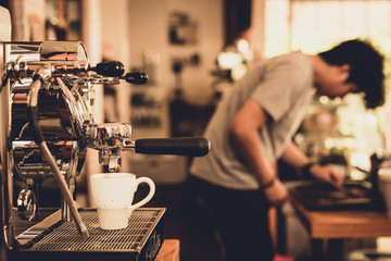 Close-up of hot coffee  from coffee machine. Professional coffee brewing