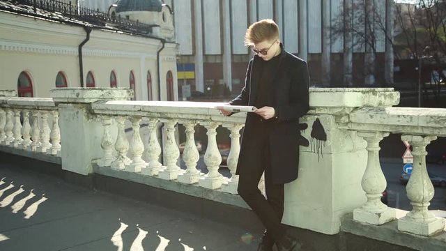 A young Man reads a nationalist Newspaper 'Nation' on the Street of Kiev Ukraine
