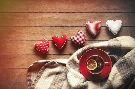 Cup of tea and scarf with heart shapes