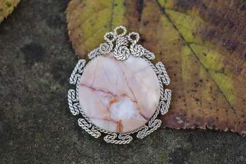 Natural stone jewelry pendant on the natural background