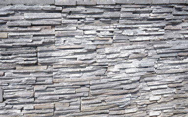 Stone background of decorative wall made of sandstone