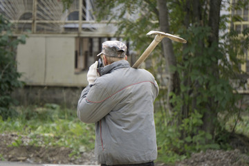 male holding shovel and looking at sky