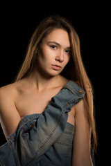 Naklejka premium Closeup portrait of tender young woman with long hair and naked shoulders