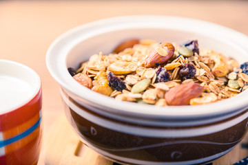 closed up of multi-grain cereal with dried fruits and nuts in an asian style bowl