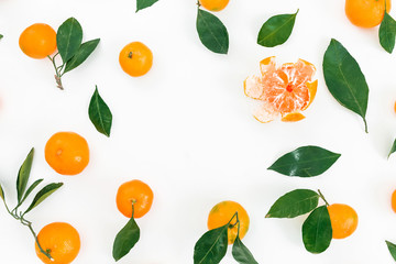 Frame made of fresh mandarin citrus and leaves on white background. Flat lay. Top view