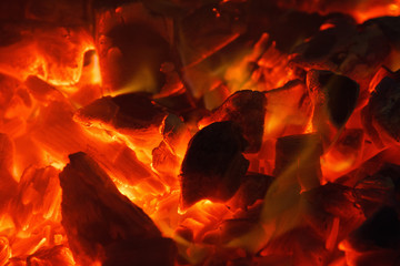 Glowing hot charcoal briquettes close up background texture. bonfire