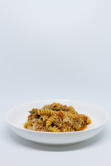 Pasta Sweet Tomato, Aubergine and Ricotta. White background. White plate. Isolated.