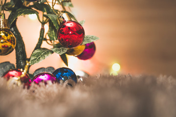 Christmas colorful ball decorative on tree with white carpet, colorful bokeh light background