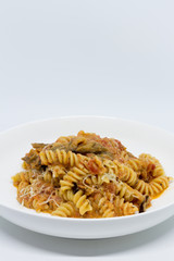 Pasta Sweet Tomato, Aubergine and Ricotta. White background. White plate. Isolated.