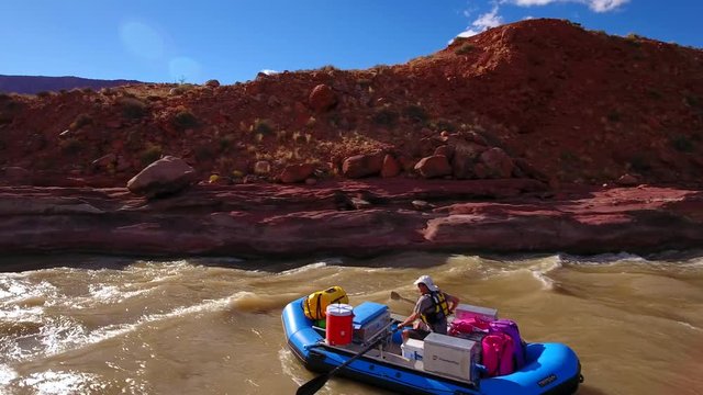 Aerial person floating down the colorado river in the dry desert