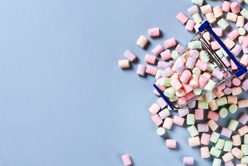 Colorful marshmallows and shopping cart