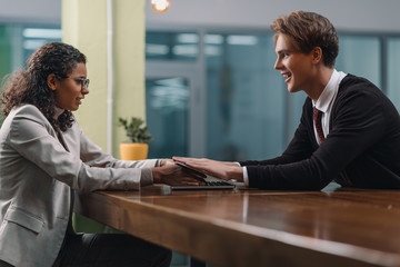 young multiethnic businesspeople working with laptop in office