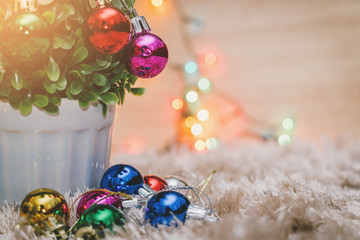 Christmas colorful ball decorative on tree with carpet , colorful bokeh light on background