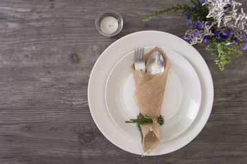 Dinner plate setting on wood table top view.