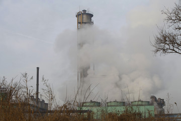 Fototapeta na wymiar Steel mills Smoke and powder dust pollution in large industrial District