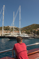 Adolescent boy travels by boat to the island of Hvar in the Adriatic