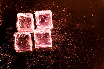 Red ice cubes and water drop background.