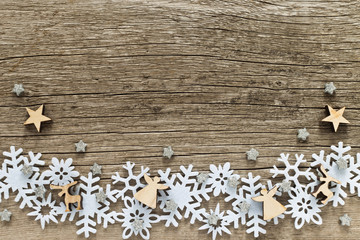 Christmas background  with white snowflakes and wooden figures