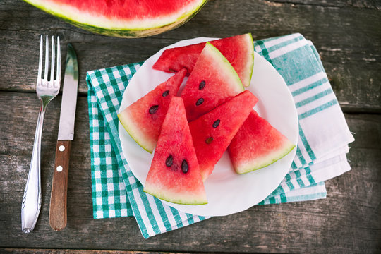 Watermelon slices with plate on cloth